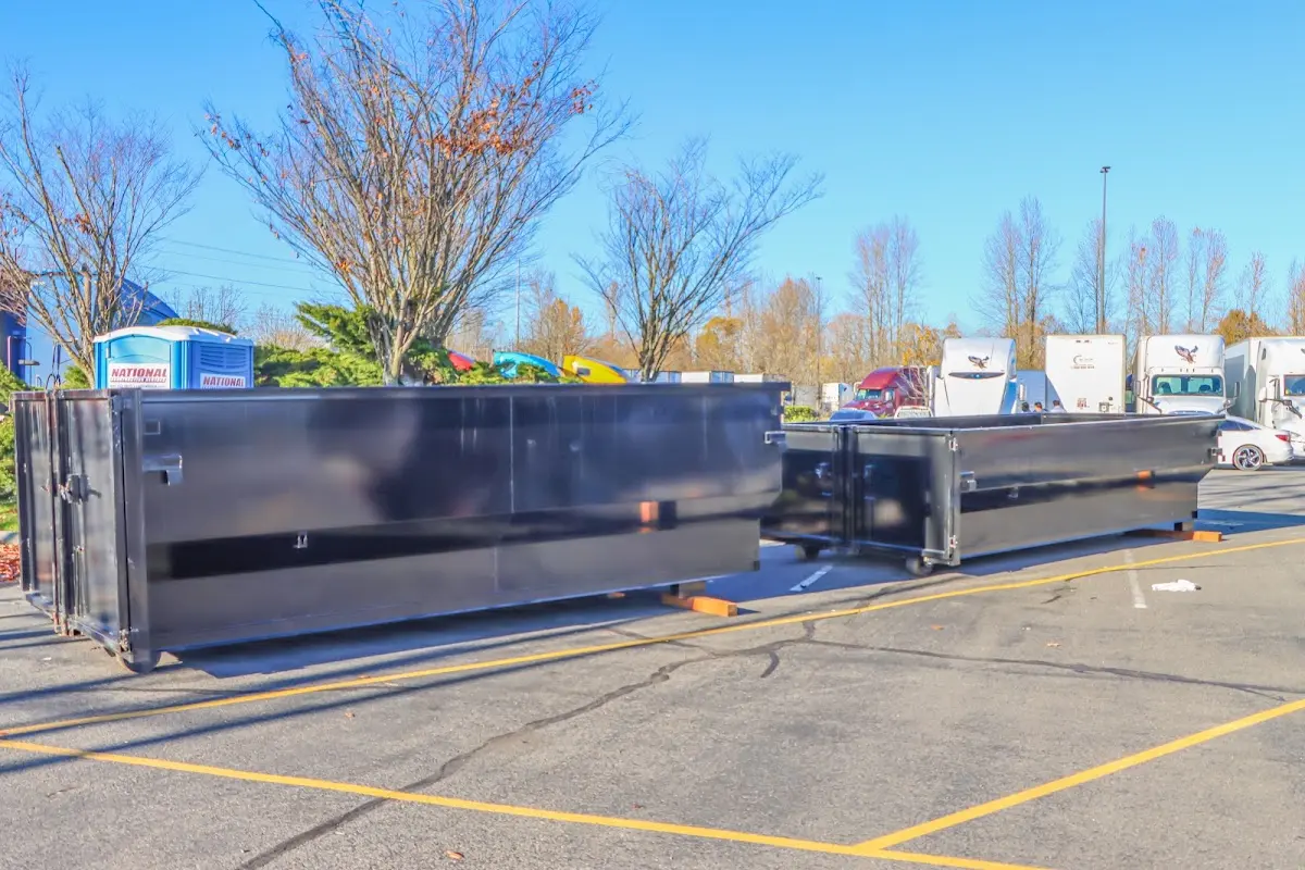 Professional dumpster rental service with roll-off container on residential driveway in Northport